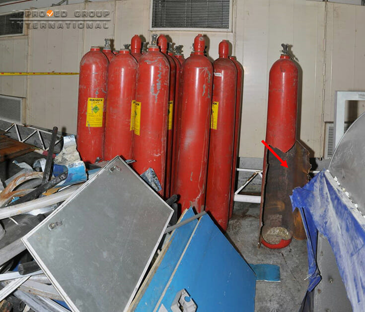 Photograph 1: Overall view of the INERGEN gas cylinders. Only one (1) INERGEN gas cylinder (red arrow) was found to have failed.