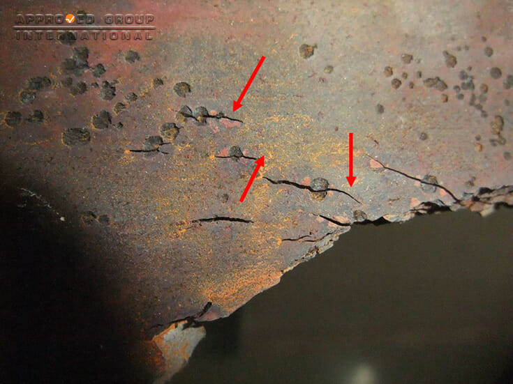 Photograph 4: Cracks (red arrows) were observed transversing along the diameter of the pits.