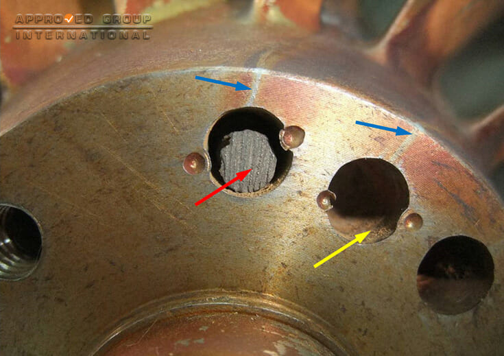 The diameter of the balancing pin (red arrow) was found to be smaller than the diameter of the hole. Oxide layer was observed within the inner surface of the hole (yellow arrow). Water marks observed indicates that water had trickled into the balancing pin’s hole (blue arrows).