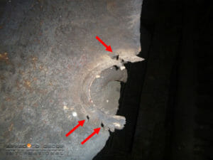 Figure 5: Multiple isolated cavities or pitting (red arrow) were observed at the welding joints on the left-side (view from the combustion chamber), connecting the water tubes and the water drum.
