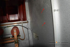 Figure 6: Whitish, powdery spots indicating condensation water marks were observed on the interior surfaces of cubicle panels (red arrows).