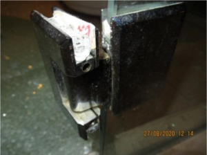 Glass Door bottom hinge with blood stain
